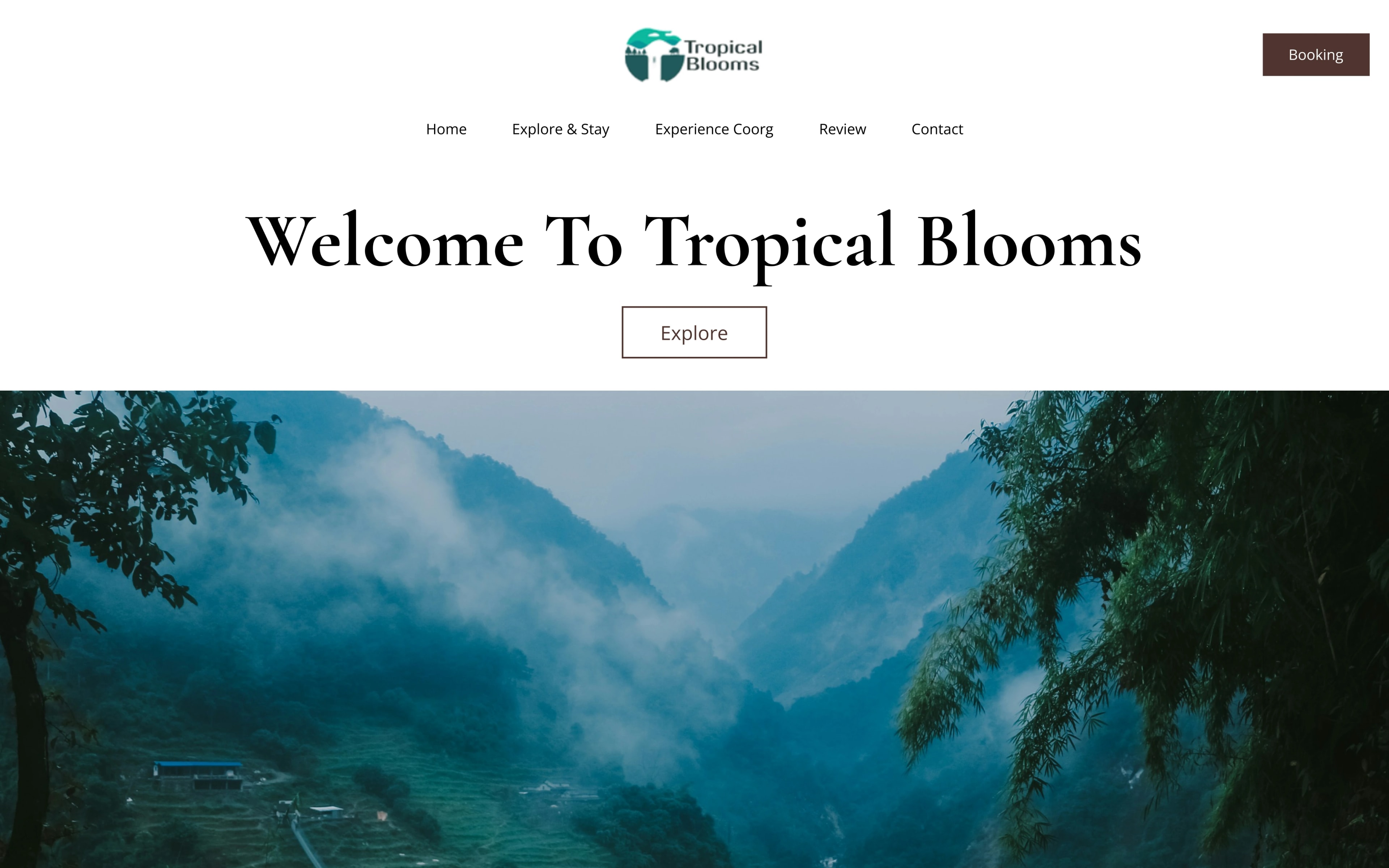 The Tropical Blooms homepage design, with the name above a misted valley in Coorg